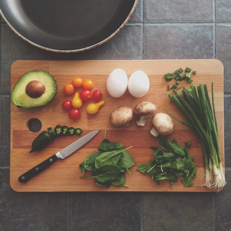 Fresh herbs and ingredients on a wooden cutting board